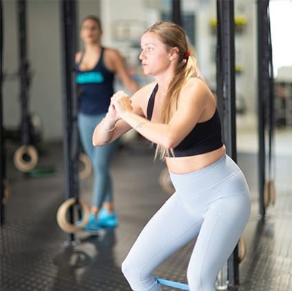 woman band training with her personal trainer